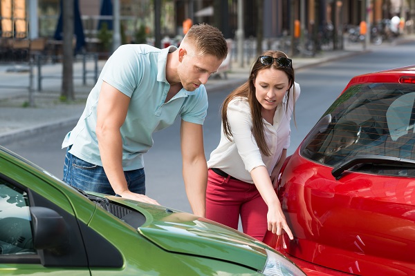 Two car accident victims discussing the vehicle damage